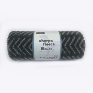 Rolled charcoal grey sherpa fleece blanket with a label, Danish Design.