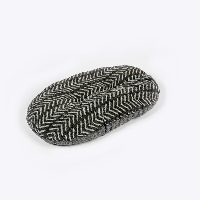 Charcoal and white chevron patterned dog bed, oval shape, fleece material, angled view.