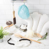 Urbana Spa Prive Body Buffer, spa and skincare accessories for body exfoliation including brushes, loofahs, and bath scrub sponges displayed on a marble surface.