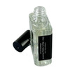 Ollie + Max Rain Perfume Oil - 1/2 oz., Clear glass perfume bottle with black cap and black label containing white text.