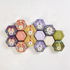 Baudelaire Royal Jelly Honey Soap - 3.5 oz., assorted colorful soap bars in hexagonal packaging with intricate botanical designs.