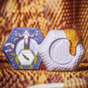 Baudelaire Lavender Honey Soap - 3.5 oz., decorative hexagonal soap with honey and lavender scent, presented alongside honey drip on textured background.
