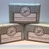 Great Meadow Arabian Sandalwood Luxurious Bath & Body Bar - 5 oz., three soap bars with silver and white patterned packaging and a label featuring the brand's logo.