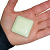 La Lavande 25g Guest Soap, a white square soap bar with embossed lavender graphics, held in a person's hand, ideal for gentle cleansing and aromatherapy.