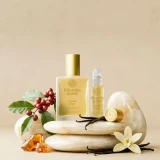 Kuumba Made Vanilla Bean Fragrance Oil - 0.15 oz. roll-top, natural vanilla scent with decorative flowers, vanilla pods, and stones, ideal for aromatherapy and perfume making.