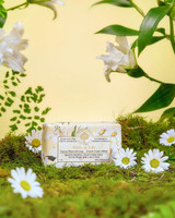 Wavertree & London Daisy & Lily Soap Bar - 200 gm, natural plant oil soap with daisies and lily flowers surrounding it on a mossy surface.