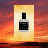 Ollie + Max Solstice Perfume Oil - 1/2 oz., a small clear glass bottle with a black cap and a black label, set against a sunset background.