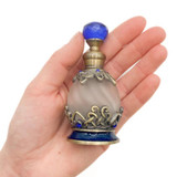 Uncommon Scents #12 Blue Perfume Bottle - 15ml Round, vintage styled perfume bottle with ornate metal details, blue accents, and a blue gem-like top held in a person's hand.