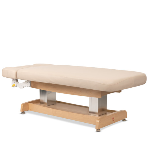 Zenith Flat Electric Spa Massage Table with Face Cradle and Armrest in Beige shown from three-quarter angle to the right fully lowered