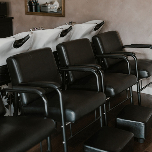 Anchorage Auto Recline Shampoo Chair in Black shown in lifestyle setting