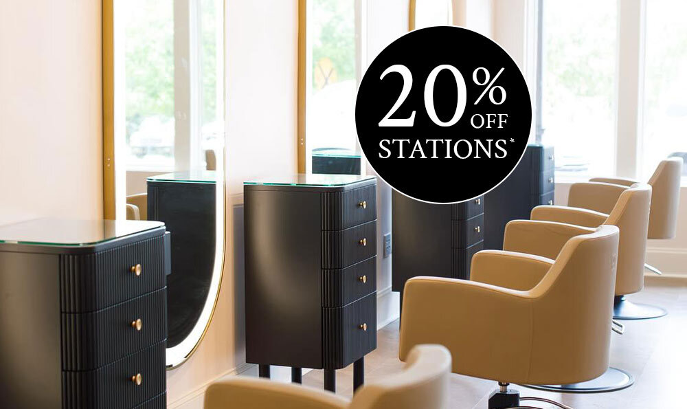 Row of black knoll styling stations, cashmere Venturi styling chairs, and gold Avalon LED mirrors