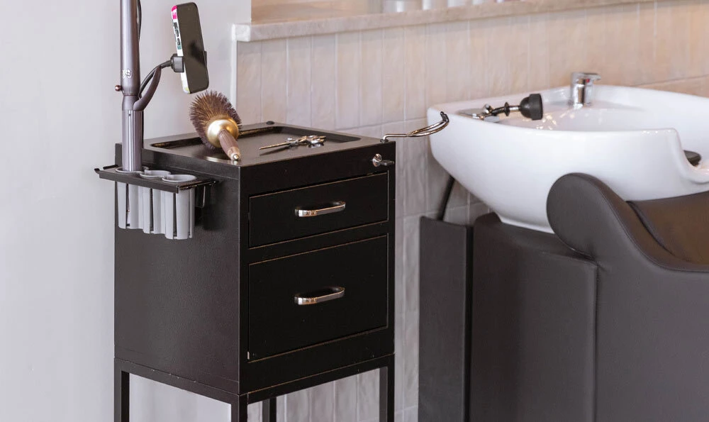 Spazio salon cart with storage and iPhone mount next to bark brown Avant shampoo system