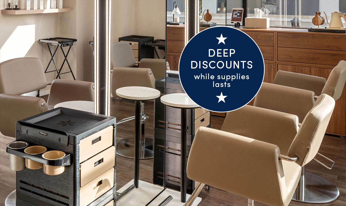 Black and beige mobile salon carts with color storage, appliance rings, and drawer storage next to LED salon mirrors and beige salon styling chairs in a salon