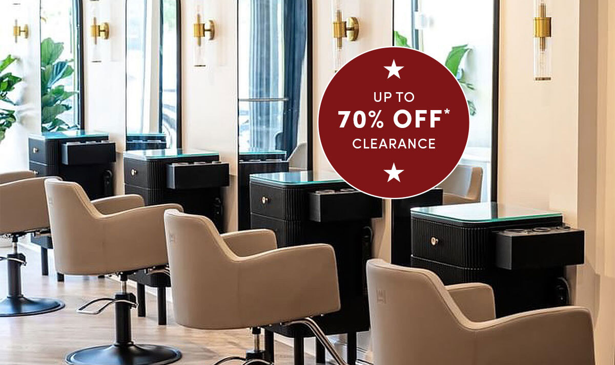 Row of saddle Venturi salon styling chairs in front of line of black knoll styling stations with wall mounted black framed mirrors