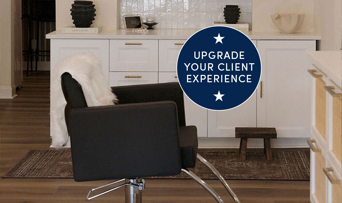 Black salon styling chairs in front of white salon styling stations in lifestyle setting