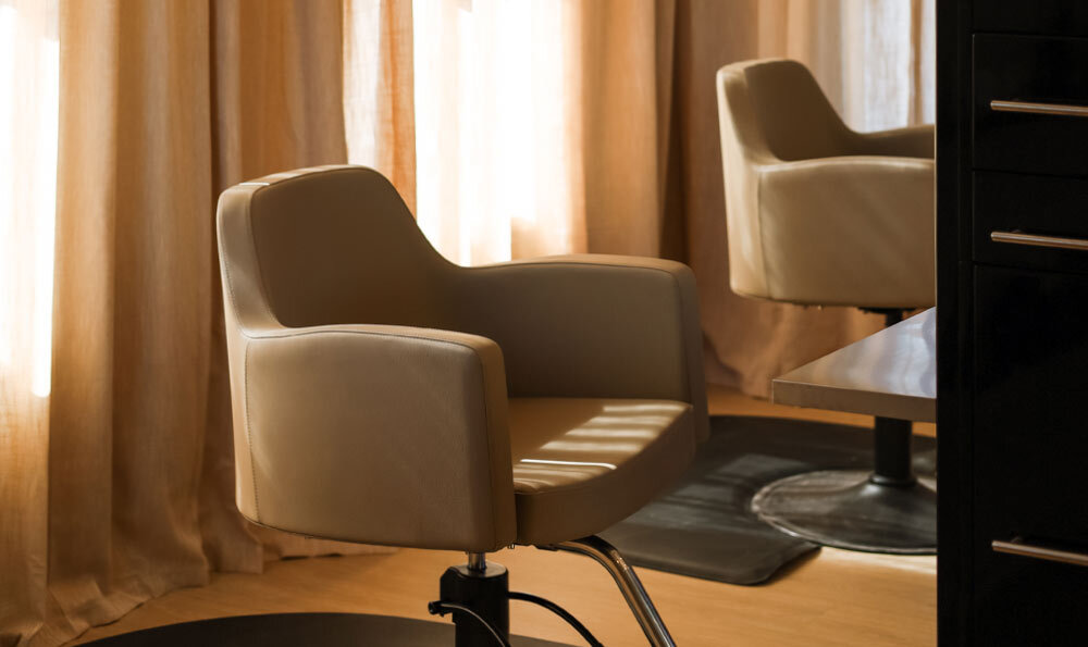 Cashmere venturi salon styling chair with black kamino styling station with gold hardware and full length shelf
