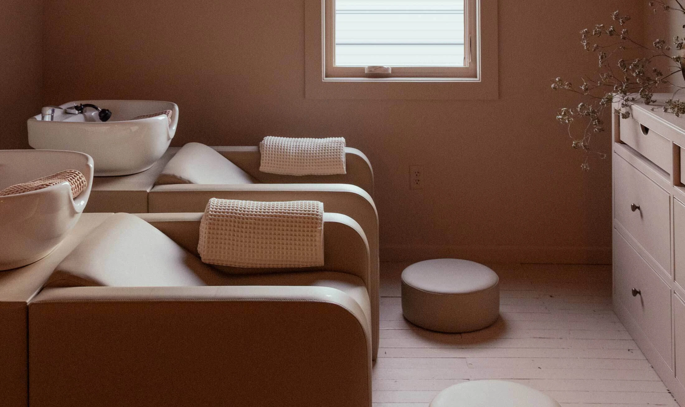 Shampoo and head spa backwash systems in beige in a salon