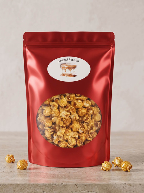 A shiny 12-ounce red heat-sealed bag of scratch-made caramel popcorn. A clear front window reveals large, golden kernels heavily coated in a rich caramel shell.