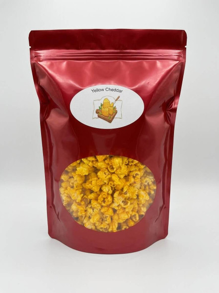 Colette's Yellow Cheddar popcorn in a 6 oz red resealable bag coated with rich golden cheddar cheese.
