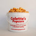 Colette's 1-gallon jumbo bucket filled with handcrafted Beach Blend popcorn, featuring a sweet and savory mix of rich copper kettle caramel and sharp yellow cheddar.