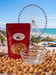 Durty Myrtle popcorn bag displayed with the Myrtle Beach oceanfront and SkyWheel in the background.