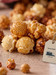 Close-up of Durty Myrtle popcorn clusters showing glazed caramel, sweet kettle corn, and buttery toffee.