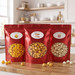 The Barefoot Sampler 3-bag gourmet popcorn deal from Colette's at Barefoot Landing, featuring red pouches of Cheddar, Caramel, and Old Fashioned Kettle Corn
