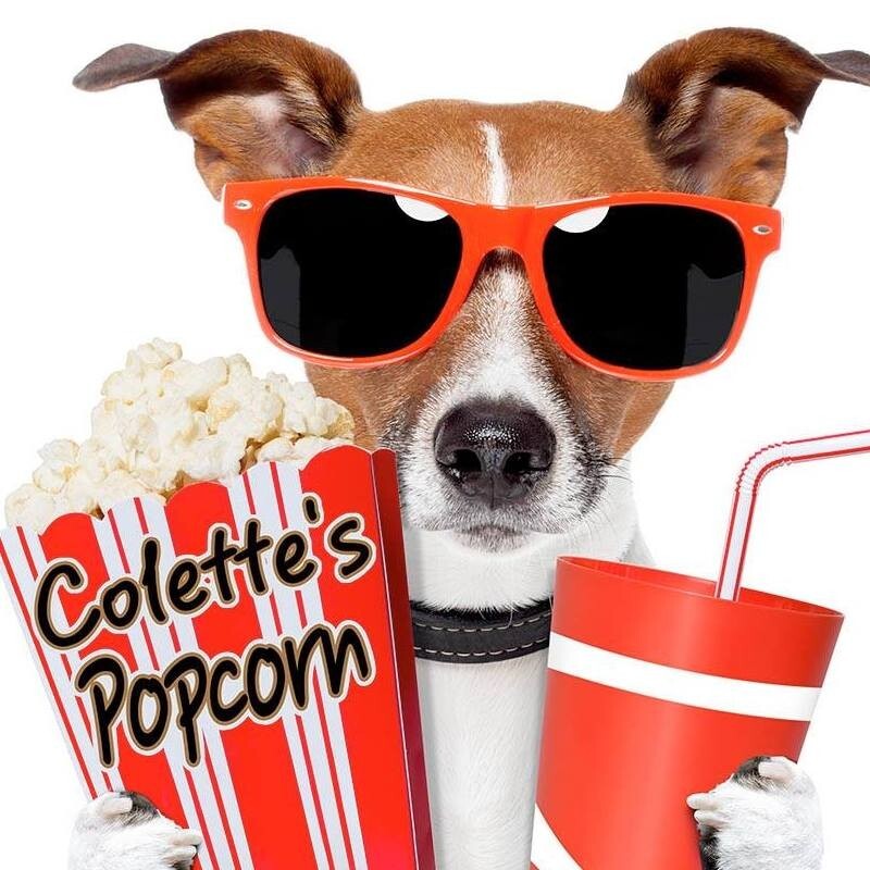 Picture of showtime the dog holding a colette's popcorn box