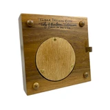 Detail: Artist signature on underside and access door to music box