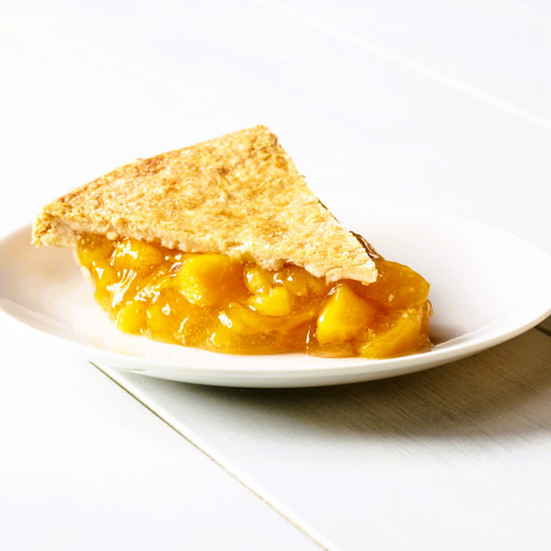 A slice of sweet and juicy Peach Pie.