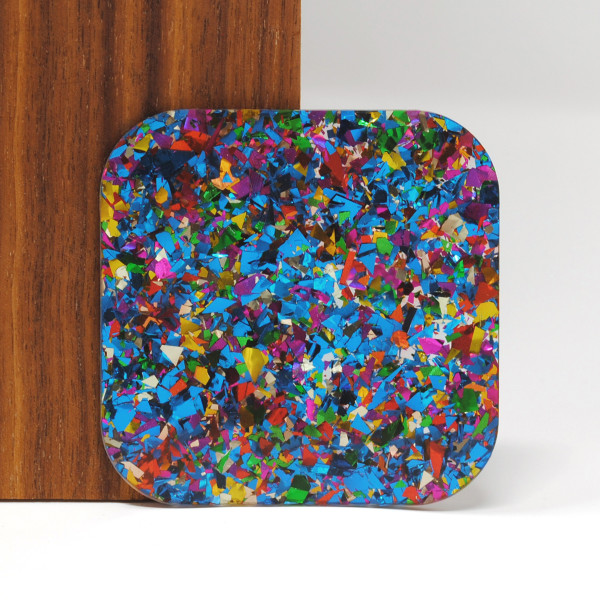 Blue Birthday Confetti acrylic sheet ??? 3mm cast acrylic with bold, multicolor glitter flakes, perfect for laser cutting, craft projects, jewelry, and decorative signage. Sample shown against wood and white background.