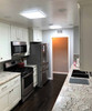 Bright kitchen with Solatube square skylight fixtures illuminating the ceiling.

