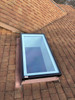 Solatube Premium Fixed Skylight with black frame installed on a shingled roof.
