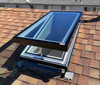 Solatube Solar-Powered Fresh Breeze Skylight, open on shingled roof.
