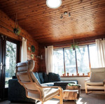 Solatube Classic Vusion Diffuser installed in a wood-paneled living room ceiling.