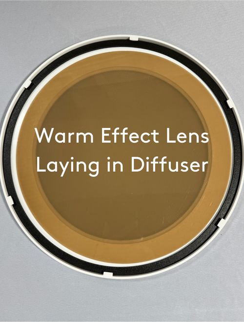 Solatube Warm Effect Lens, a circular, warm-toned filter within a white and black diffuser frame. Solatube Warm Effect Lens, a circular, warm-toned filter within a white and black diffuser frame.