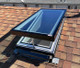 Solatube Solar-Powered Fresh Breeze Skylight, open on shingled roof.
