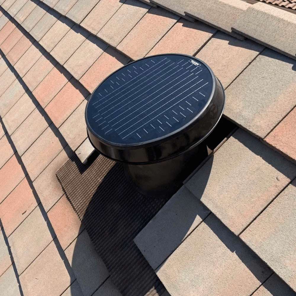 Solatube hurricane-rated solar attic fan installed on a clay tile roof