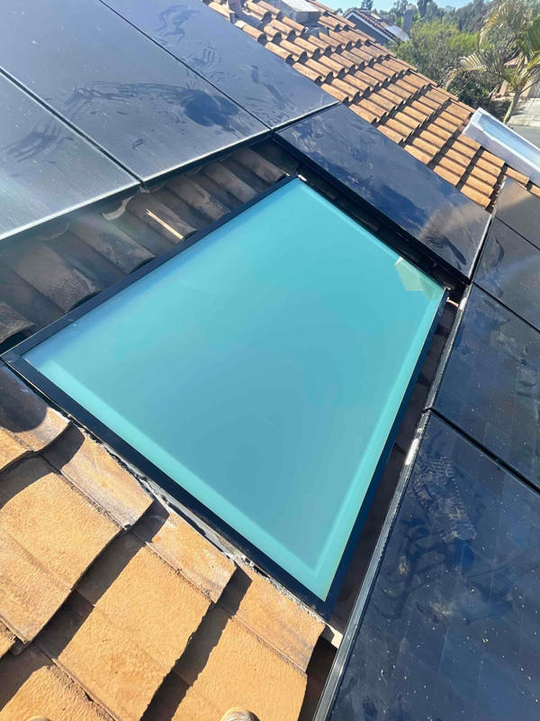 Rectangular Solatube fixed skylight installed on a tiled roof