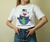 Sale - White Short Sleeve T-Shirt With Champagne Cat® Hugging Earth Graphic