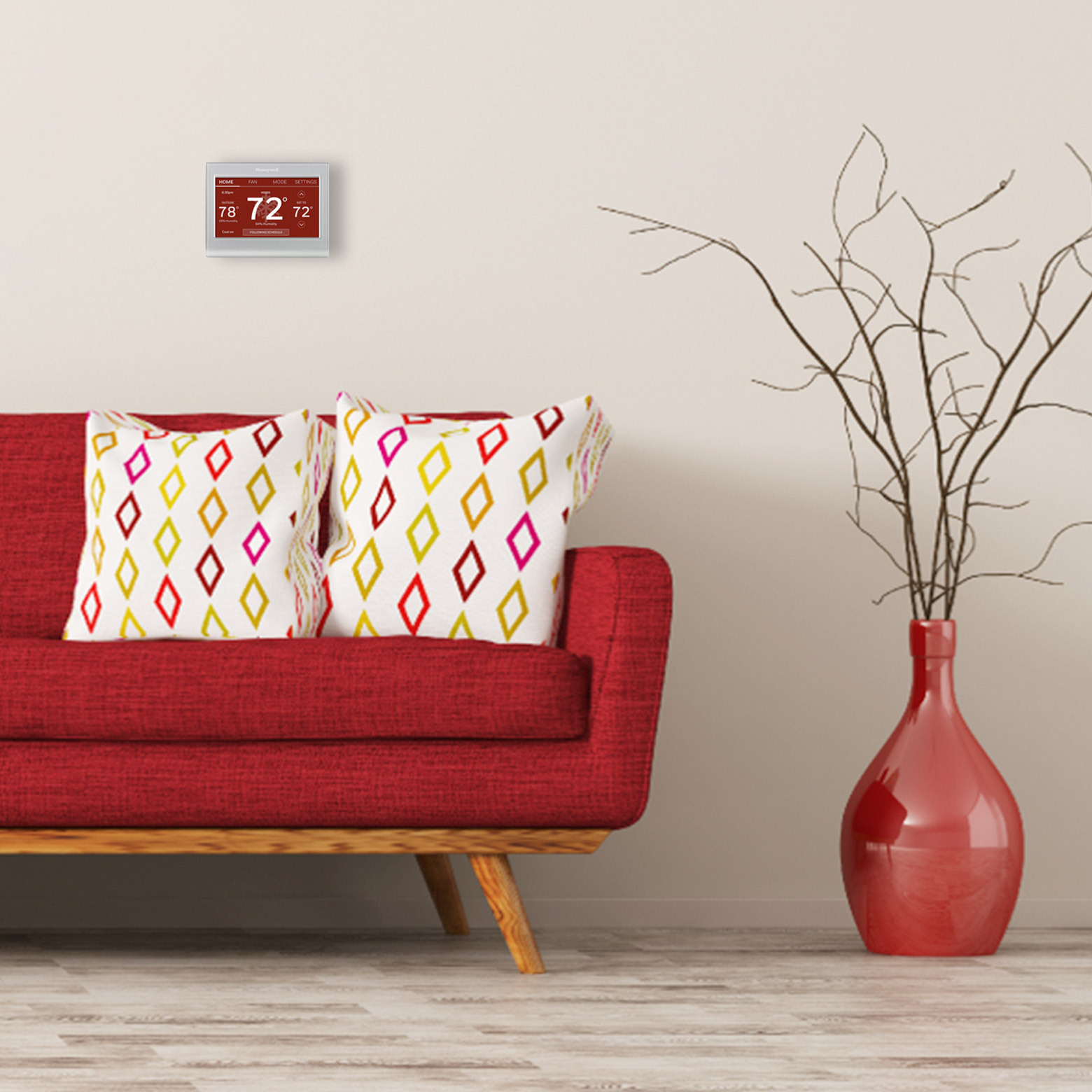 red thermostat face in living room with red couch