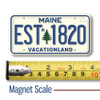 Maine License Plate Magnet displayed with a measuring tape for size reference.