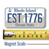 Rhode Island License Plate Magnet displayed with a measuring tape for size reference. Rhode Island License Plate Magnet displayed with a measuring tape for size reference.
