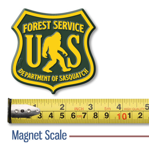 Department of Sasquatch magnet shown above a tape measure for size reference, shaped like a U.S. Forest Service badge with Bigfoot design.