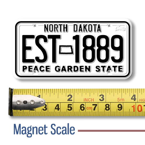 North Dakota License Plate Magnet displayed with a measuring tape for size reference.