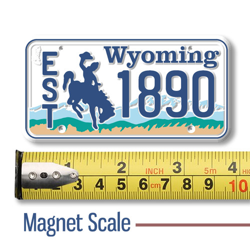 Wyoming License Plate Magnet displayed with a measuring tape for size reference.