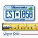 Minnesota License Plate Magnet displayed with a measuring tape for size reference.