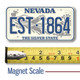Nevada License Plate Magnet displayed with a measuring tape for size reference.
