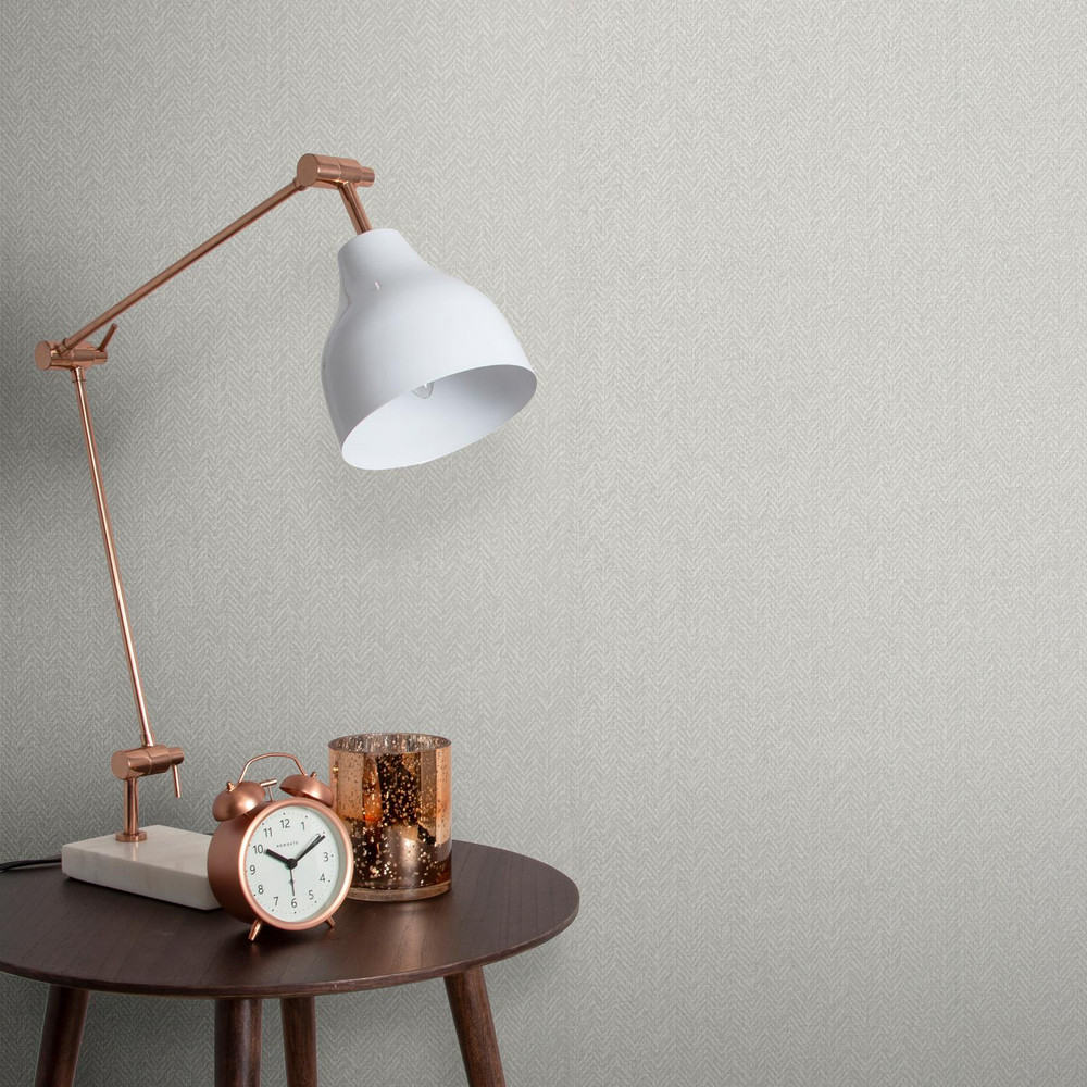A herringbone-texture effect wallpaper on a wall, styled in warm neutrals