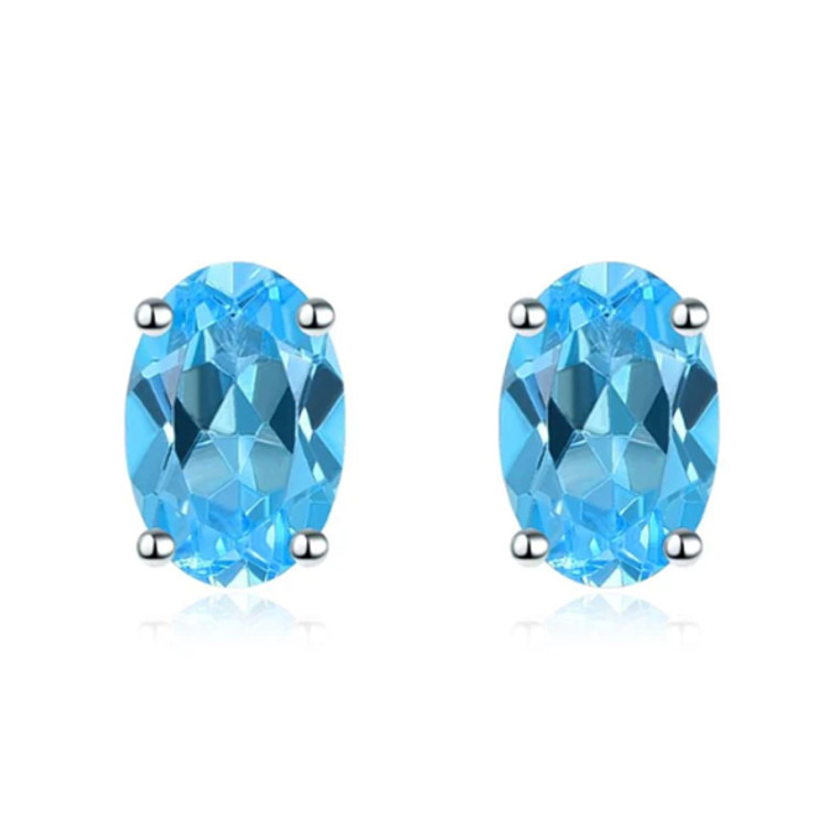 Oval Blue Topaz Studs in White Gold